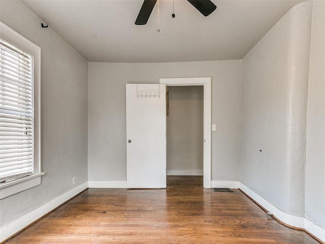 spare room with hardwood / wood-style flooring, ceiling fan, and a wealth of natural light