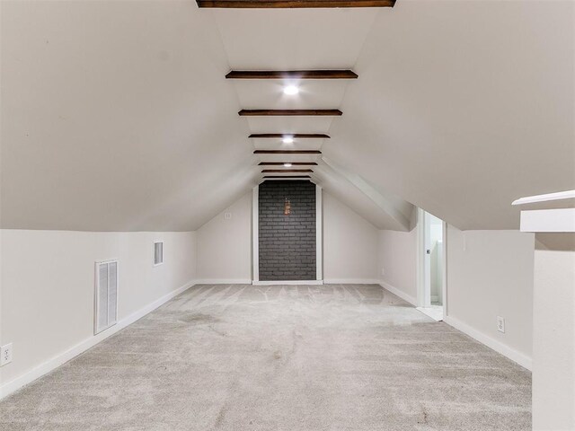 bonus room featuring vaulted ceiling with beams and light colored carpet