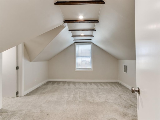 additional living space featuring light carpet and vaulted ceiling