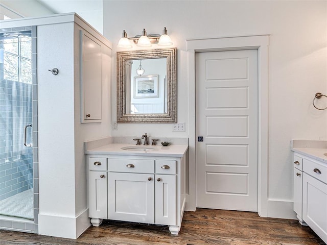 bathroom featuring vanity, an enclosed shower, and hardwood / wood-style flooring