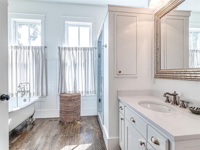 bathroom featuring hardwood / wood-style floors, independent shower and bath, and a healthy amount of sunlight