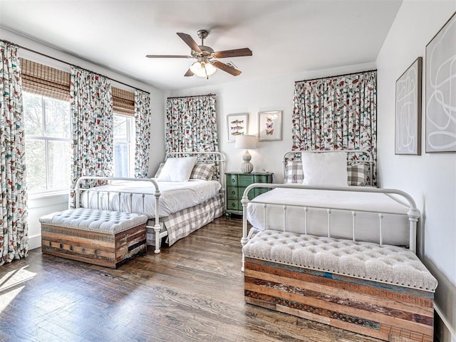 bedroom with dark hardwood / wood-style floors and ceiling fan