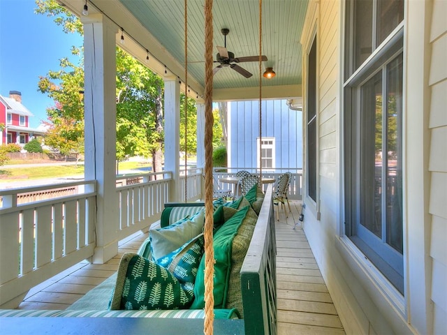 balcony with ceiling fan and a porch