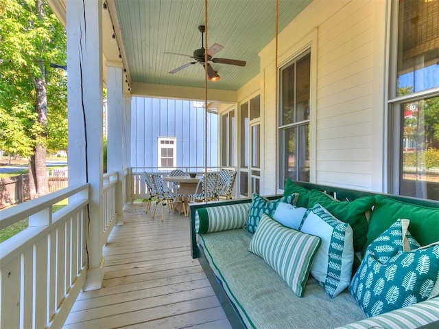 wooden terrace featuring ceiling fan and an outdoor hangout area