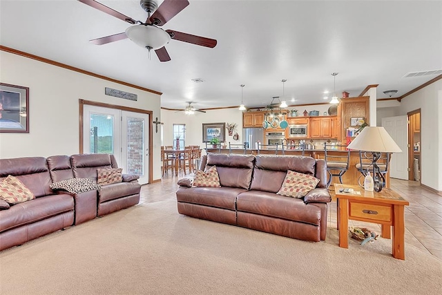 living room featuring ceiling fan, ornamental molding, and light tile patterned floors