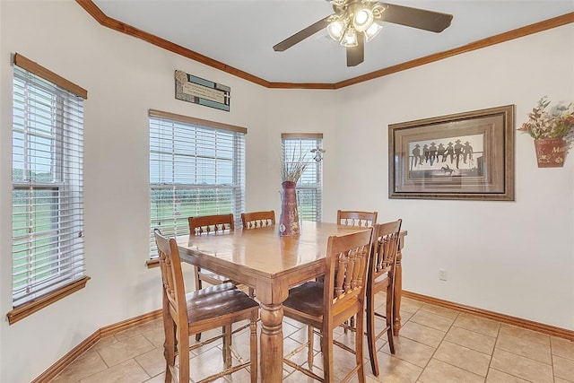 tiled dining area with ceiling fan, ornamental molding, and a wealth of natural light