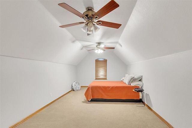 bedroom featuring carpet floors, vaulted ceiling, and ceiling fan