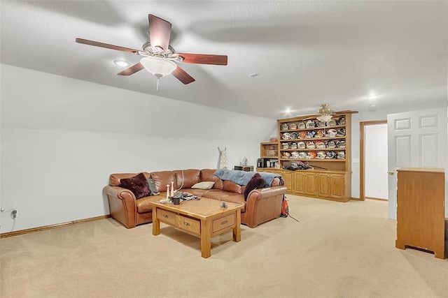 carpeted living room with ceiling fan and lofted ceiling