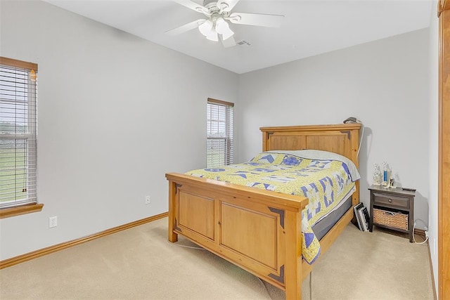 bedroom with ceiling fan and light colored carpet