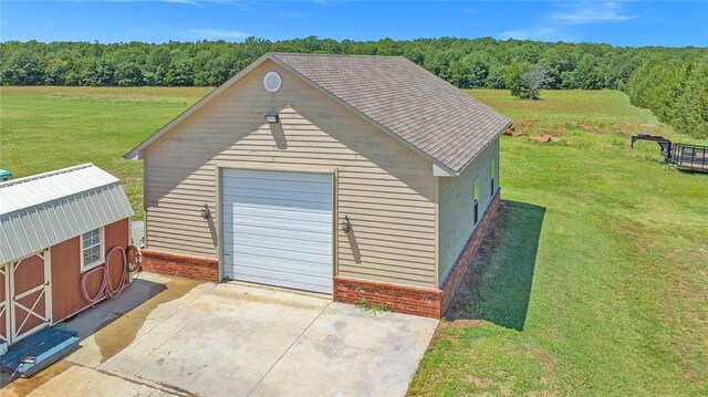 view of outbuilding featuring a lawn and a garage