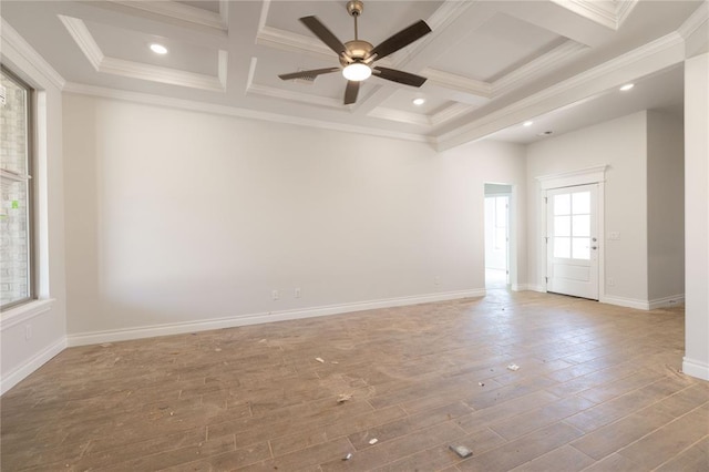 spare room with ornamental molding, coffered ceiling, baseboards, and wood finished floors