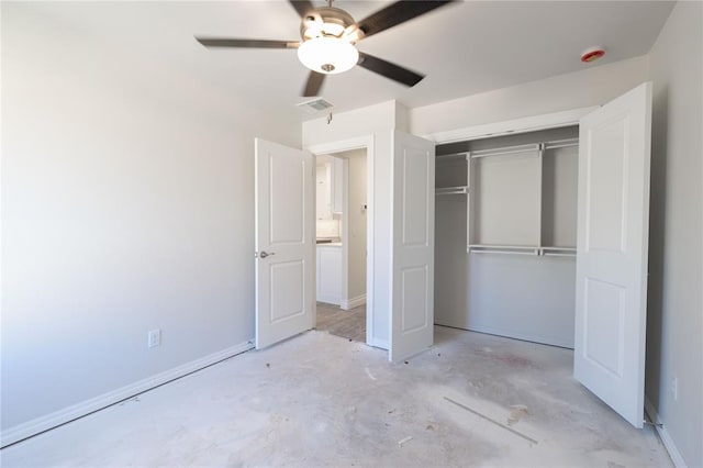 unfurnished bedroom with a closet, unfinished concrete flooring, baseboards, and visible vents