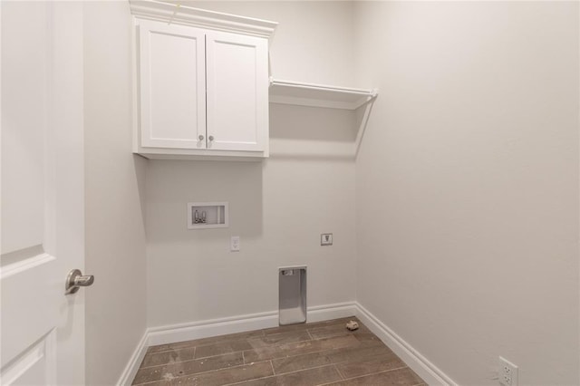 washroom featuring baseboards, wood tiled floor, washer hookup, cabinet space, and electric dryer hookup