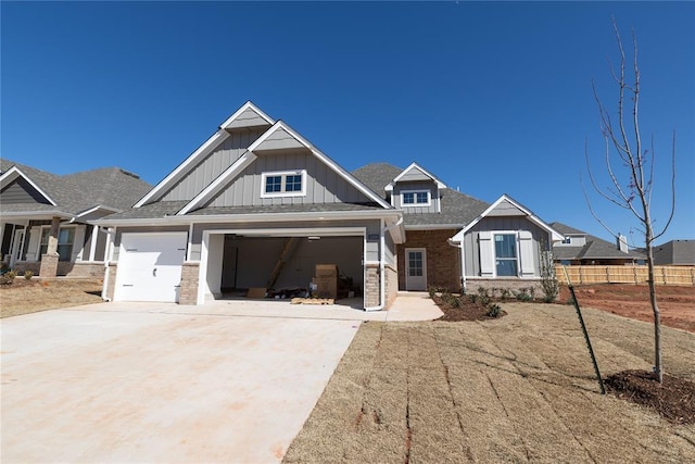 craftsman house with fence, driveway, a garage, board and batten siding, and brick siding