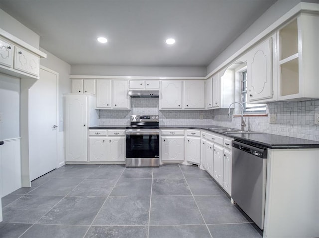 kitchen featuring decorative backsplash, sink, white cabinetry, and stainless steel appliances