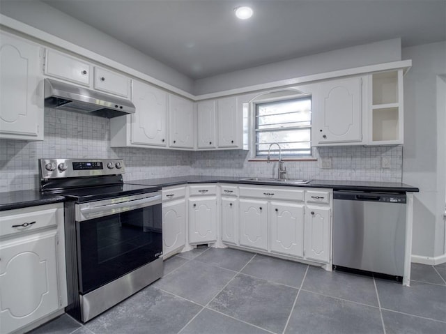 kitchen featuring white cabinets, backsplash, stainless steel appliances, and sink