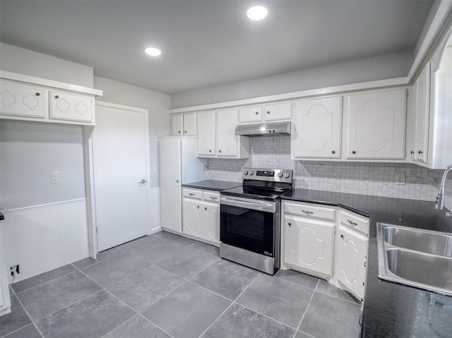 kitchen with stainless steel range with electric stovetop, decorative backsplash, white cabinetry, and sink