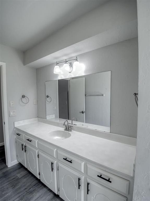 bathroom featuring vanity and wood-type flooring