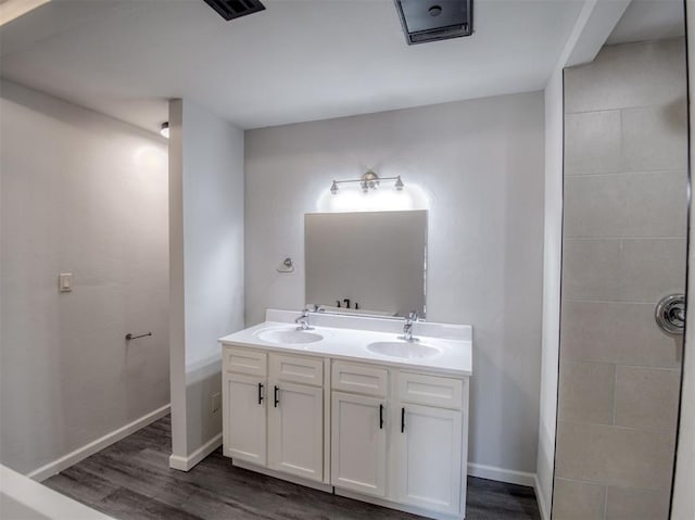 bathroom with vanity and wood-type flooring