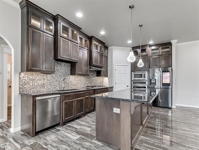 kitchen with pendant lighting, a center island, sink, appliances with stainless steel finishes, and dark brown cabinets