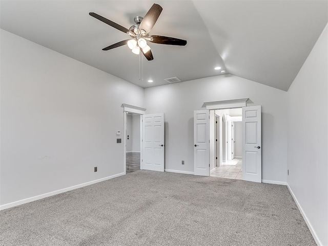 unfurnished bedroom featuring light colored carpet, ceiling fan, and lofted ceiling