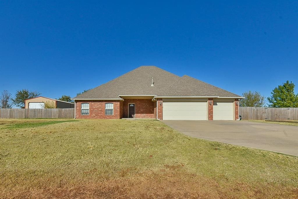 ranch-style home with a front lawn and a garage