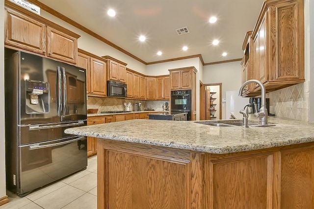 kitchen with sink, kitchen peninsula, light tile patterned floors, black appliances, and ornamental molding