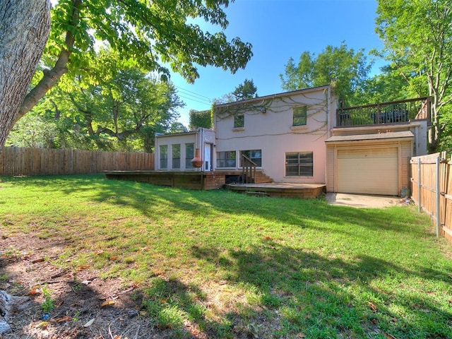 rear view of property featuring a garage and a yard