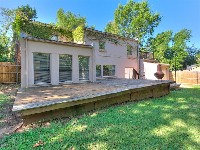 back of house with a lawn and a wooden deck