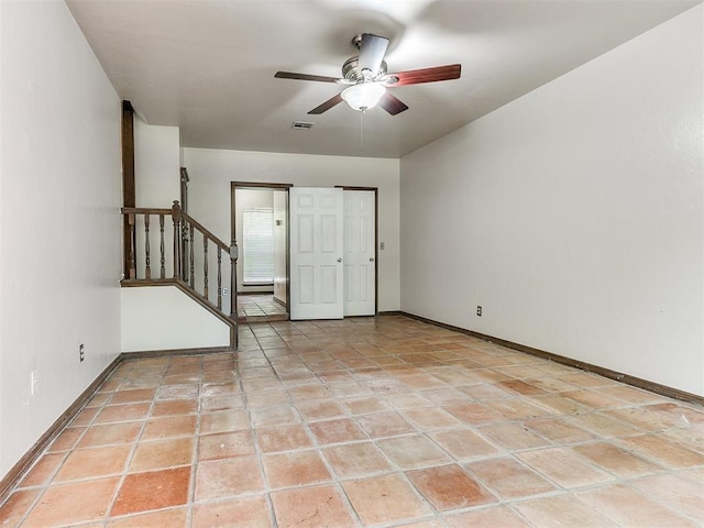 spare room featuring ceiling fan and light tile patterned floors