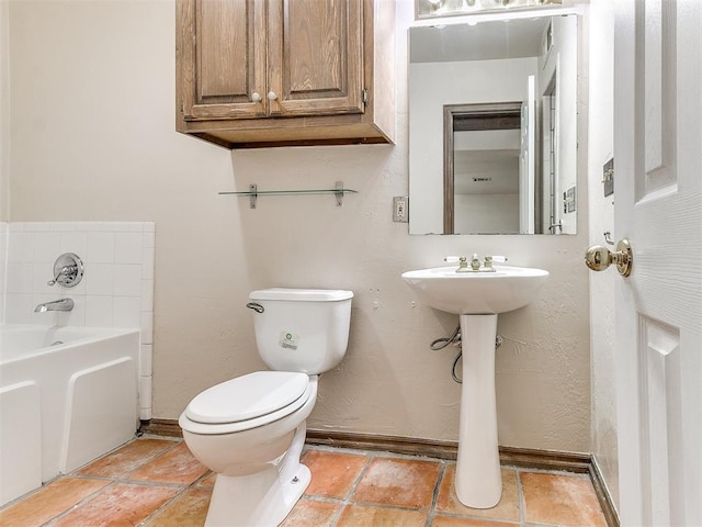 bathroom featuring toilet and a tub to relax in