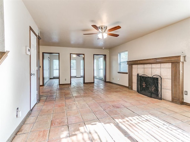 unfurnished living room featuring light tile patterned floors, ceiling fan, and a tiled fireplace