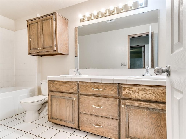 bathroom featuring tile patterned flooring, vanity, and toilet