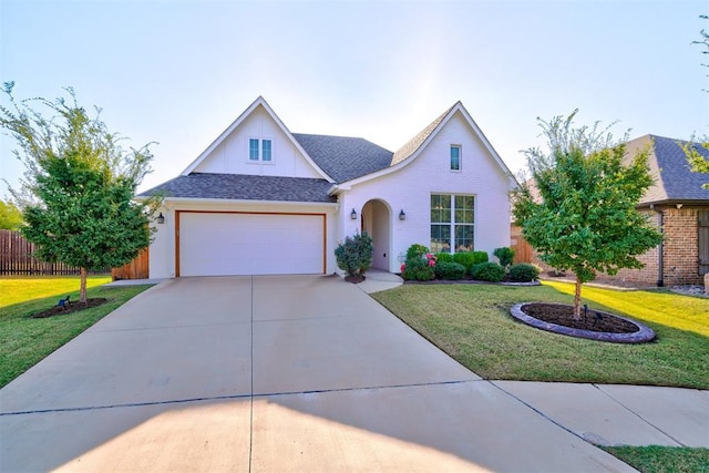 view of front of home featuring a front yard and a garage