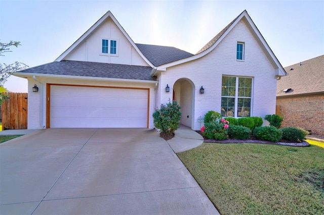 view of front of home featuring a garage and a front lawn