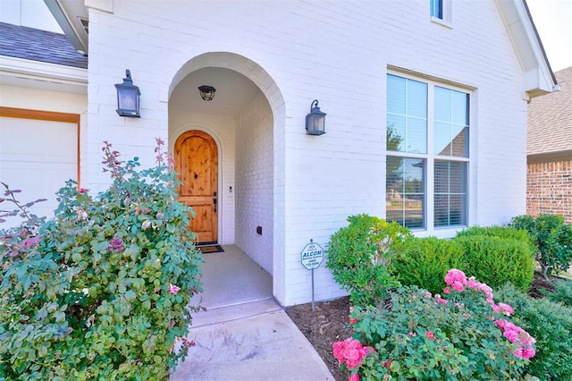 doorway to property with a garage