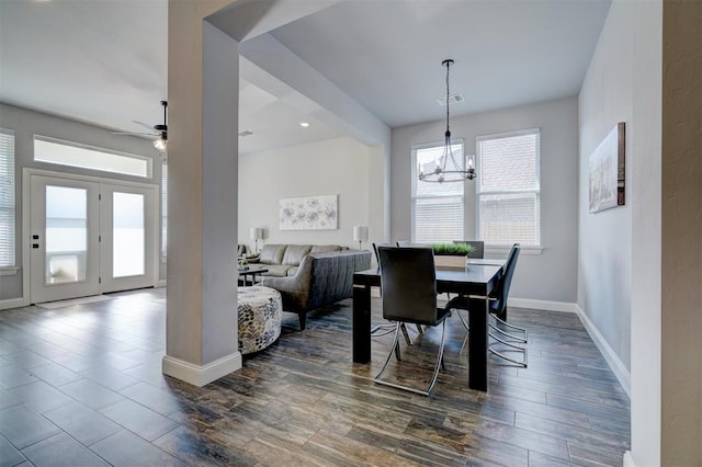 dining room featuring a wealth of natural light, dark hardwood / wood-style flooring, and ceiling fan with notable chandelier