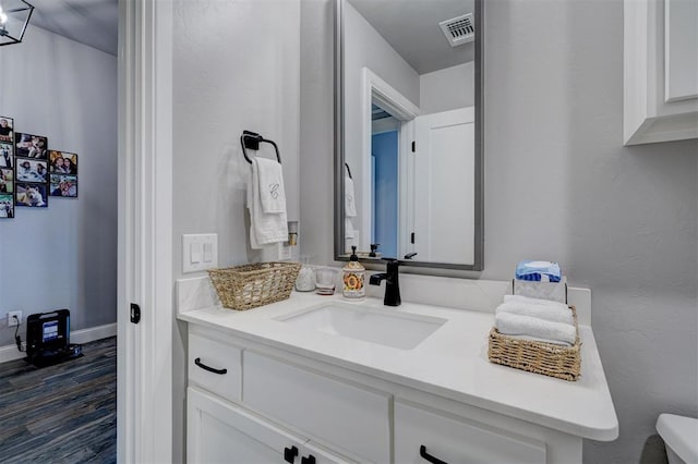 bathroom with hardwood / wood-style floors and vanity