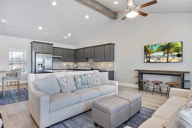 living room with beam ceiling, light wood-type flooring, high vaulted ceiling, and ceiling fan