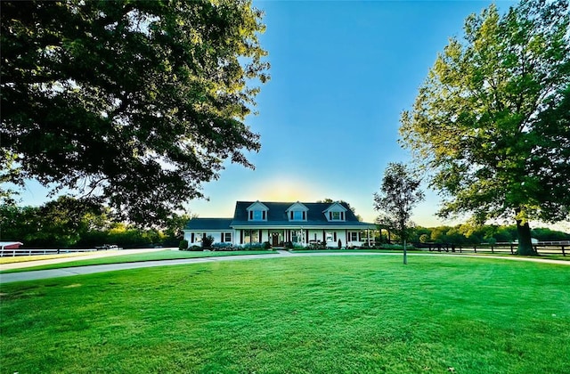 new england style home featuring a front yard