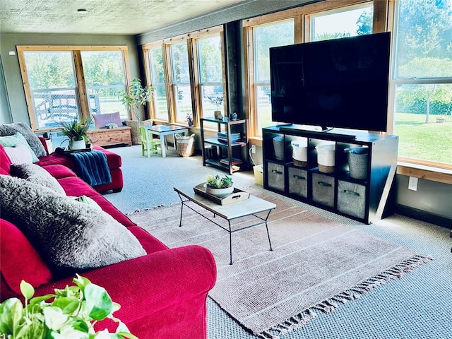 carpeted living room featuring a textured ceiling