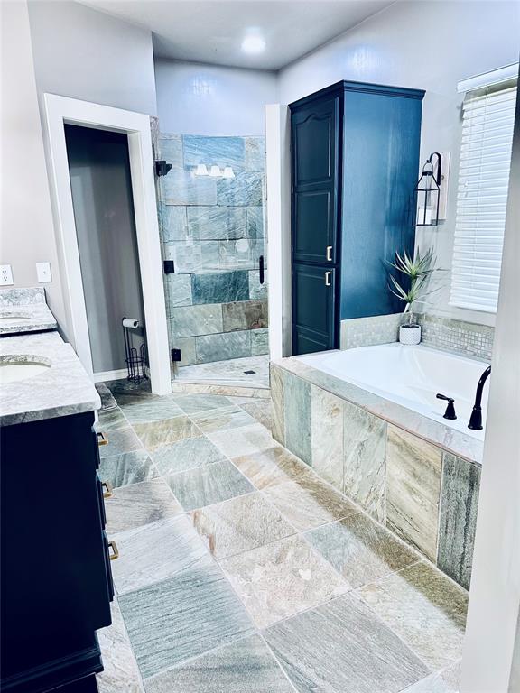 bathroom with separate shower and tub and vanity