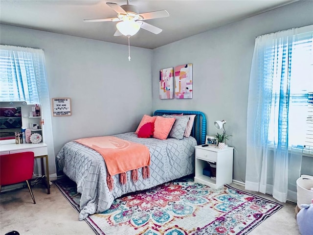 bedroom featuring multiple windows, ceiling fan, and carpet floors