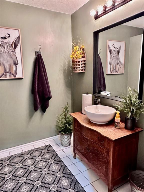 bathroom featuring tile patterned floors, vanity, and a textured ceiling