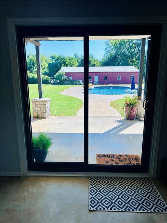 entryway featuring a wealth of natural light and concrete floors