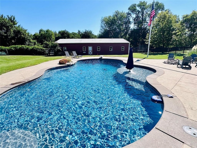 view of swimming pool with a lawn, a diving board, and a patio