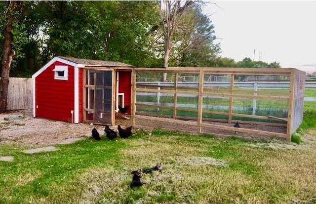 view of outbuilding featuring a lawn