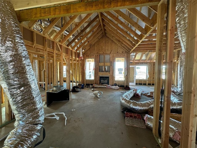 misc room featuring a fireplace and a high ceiling