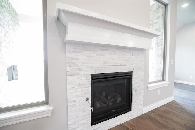 9309 Cheek Ranch Rd, Yukon, OK 73099 - room details with baseboards, a stone fireplace, and wood finished floors