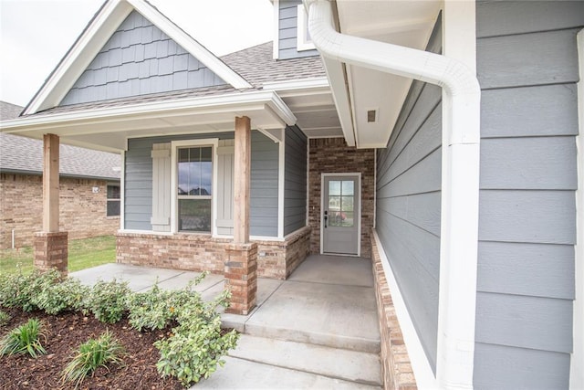 9309 Cheek Ranch Rd, Yukon, OK 73099 - view of exterior entry with a porch and a shingled roof